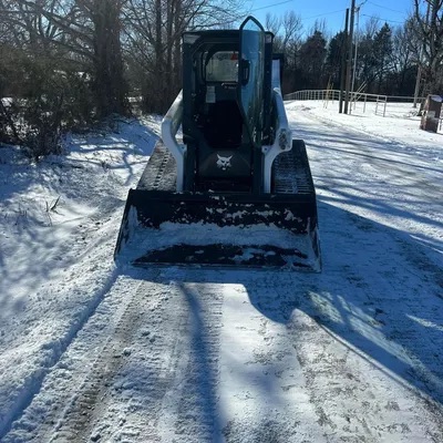 Clearing snow with a loader bucket